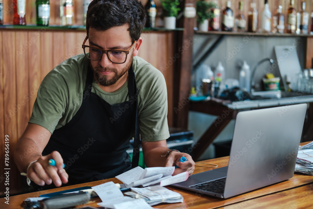 Working With Receipts And A Computer Doing Financial Work Stockpack Adobe Stock Business owner applying for accounts receivable finance in South Africa